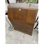 AN OAK BUREAU WITH FALL FRONT AND THREE DRAWERS