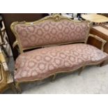 A NINETEENTH CENTURY GILDED THREE SEATER SOFA