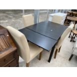 A MODERN BLACK DRAW-LOAF DINING TABLE AND FOUR UPHOLSTERED CHAIRS