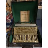 A CASED ROSETTI ACCORDIAN WITH A FELDMANS PIANO ACCORDIAN TUTOR BOOK