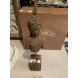 AN ANTIQUE STONE BUDDHA HEAD AND UPPER BODY ON A STEEL PLINTH 39CM