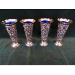 A HALLMARKED 1893 LONDON SILVER SET OF FOUR TRUMPET SHAPED FLOWER VASES, EACH WITH BLUE GLASS