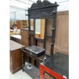 A CARVED OAK HALL STAND WITH CENTRAL MIRROR AND GLOVE BOX