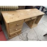 A PINE DESK WITH FOUR DRAWERS (DOOR MISSING)