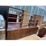 A LARGE MAHOGANY LIBRARY CABINET WITH THREE DOORS AND UPPER SHELVING