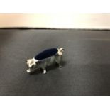 A SILVER PIG PIN CUSHION