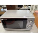 A SHARP MICROWAVE BELIEVED IN WORKING ORDER - NO WARRANTY