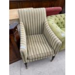 A NINETEENTH CENTURY REGENCY STYLE FIRESIDE ARMCHAIR ON TURNER FRONT LEGS WITH CASTERS