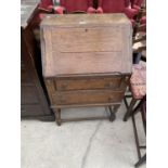 A SMALL EARLY 20TH CENTURY OAK BUREAU WITH FALL FRONT AND TWO DRAWERS