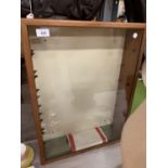 A TABLE TOP DISPLAY CABINET WITH GLASS SHELVES