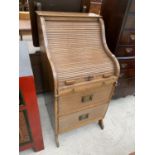 AN OAK ROLL TOP DESK WITH TWO FITTED DRAWERS AND SLIDE OUT WRITING SURFACE