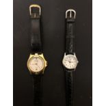 TWO LADIES FASHION WATCHES BOTH WITH BLACK LEATHER STRAP