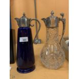 TWO CLARET JUGS ONE BLUE GLASS AND ONE CUT GLASS WITH ORNATE MAN BEAST POURER