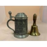 A SMALL BRASS AND WOODEN HANDLED SCHOOL BELL TOGETHER WITH AN ORNATE GERMAN PEWTER STEIN