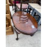 A TWENTIETH CENTURY WALNUT COFFEE TABLE ON BALL AND CLAW FEET