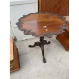 A MAHOGANY TRIPOD TABLE WITH SCALLOPED EDGE ON CLAW FEET