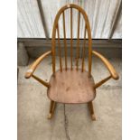 AN ERCOL CHILD'S ELM SEATED ARCH BACK ROCKING CHAIR