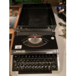 A CASED SILVER REED LEADER TYPE WRITER