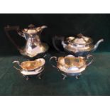 A HALLMARKED 1917 SHEFFIELD SILVER COMPOSITE FOUR PIECE TEA SERVICE, COMPRISING A TEAPOT, HOT