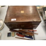 A MAHOGANY WRITING SLOPE WITH GLASS INKWELL AND FOUNTAIN PENS