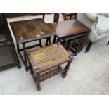 AN OAK STOOL WITH WOVEN SEAT AND A SMALL OAK COFFEE TABLE , BOTH ON BARLEY TWIST SUPPORTS AND AN OAK