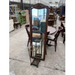 A CARVED MAHOGANY DRESSING MIRROR AND A BRASS STICK STAND