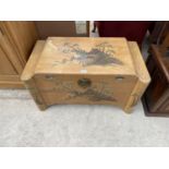 A CAMPHOR WOOD BEDDING CHEST WITH ORIENTAL DECORATION
