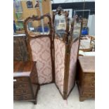 A VICTORIAN WALNUT THREE SECTION SCREEN WITH GLASS PANELS AND HEAVILY CARVED DECORATION TO THE UPPER