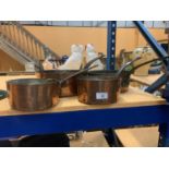 FOUR GRADUATED COPPER PANS