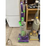 A PURPLE AND GREEN DYSON DC04 VACUUM CLEANER