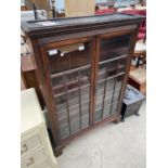 A 19TH CENTURY MAHOGANY CABINET WITH TWO GLAZED PANEL DOORS