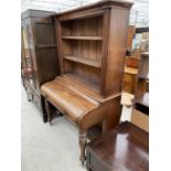 A VICTORIAN MAHOGANY BOOKCASE DESK WITH SHAPED LID REVEALING CONCEALED SLIDE OUT LEATHER WRITING