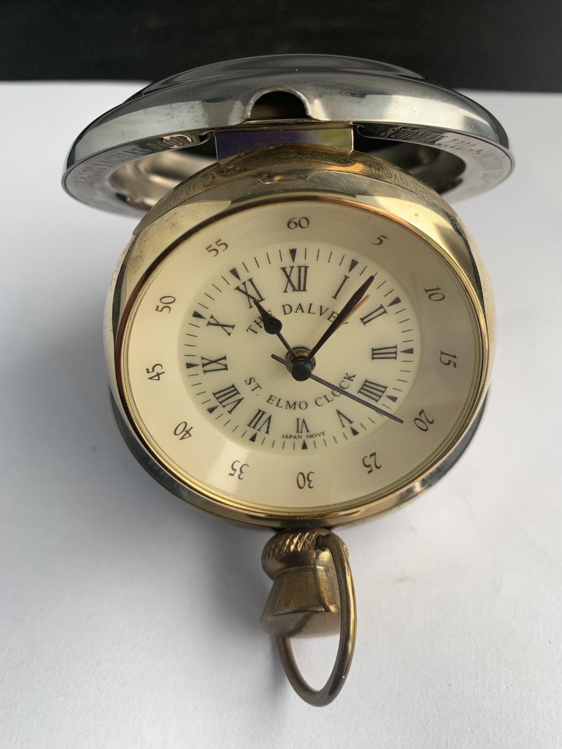 A 'THE DALVEY ST ELMO' TRAVELLING ALARM CLOCK IN THE FORM OF A LARGE POCKET WATCH