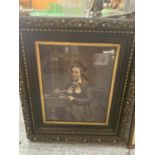 A LARGE ORNATE GILT AND BLACK FRAME CONTAINING A PICTURE OF A VICTORIAN WOMAN