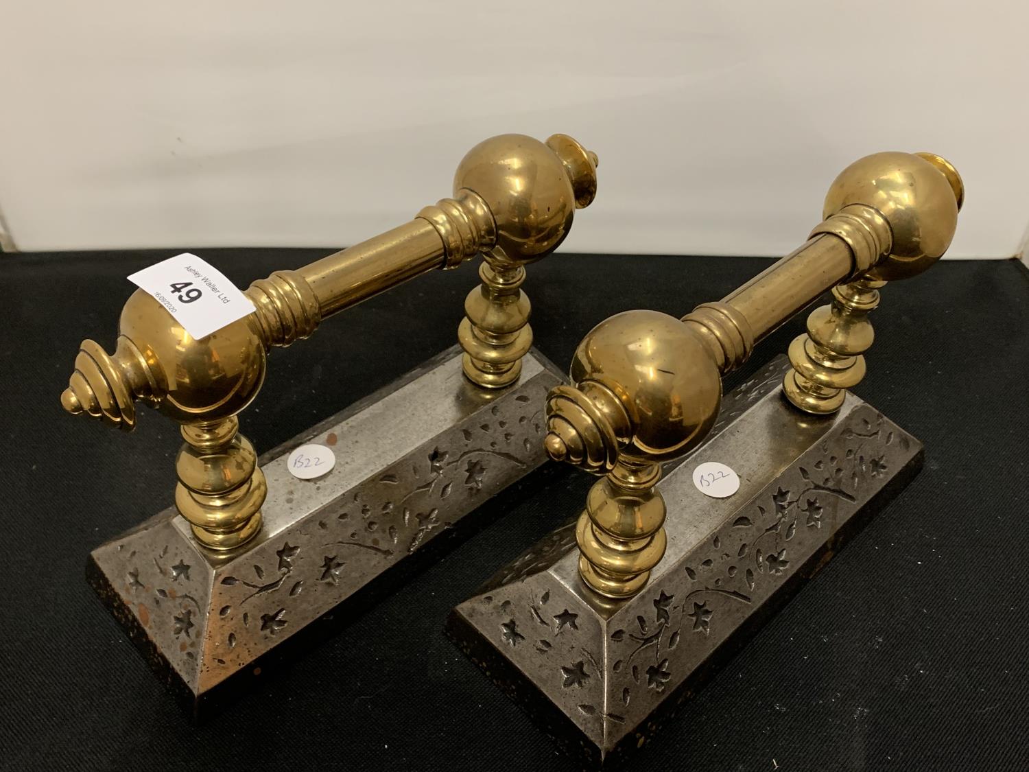 A PAIR OF BRASS FIRE IRON RESTS