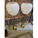 A PAIR OF VICTORIAN BRASS ADJUSTABLE HEIGHT OIL LAMPS WITH WHITE GLASS SHADES