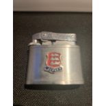 A CIGARETTE LIGHTER WITH A JERSEY COAT OF ARMS