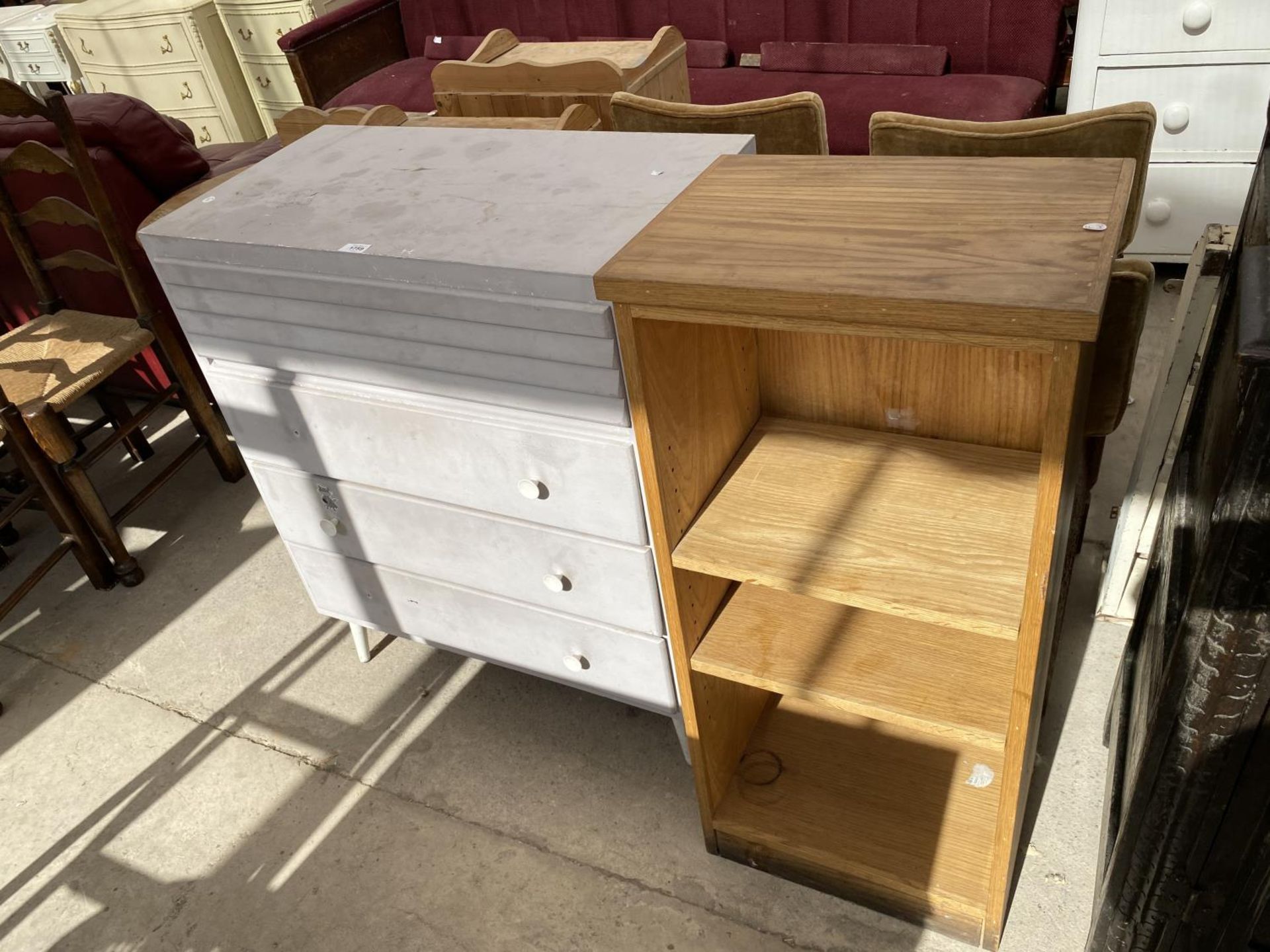 A SMALL PAINTED CHEST OF DRAWERS AND AN OPEN BOOKCASE