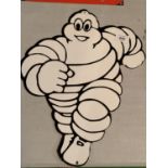 A METAL RUNNING MICHELIN MAN SIGN