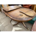 A MAHOGANY EXTENDING DINING TABLE ON TWIN PEDESTAL SUPPORTS