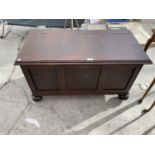 AN OAK BLANKET CHEST WITH PANELED FRONT