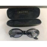 A PAIR OF GUCCI SUNGLASSES WITH CASE