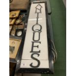 A LARGE BLACK METAL LIGHT BOX SHOP SIGN 'ANTIQUES'