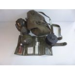 A MILITARY GAS MASK AND EXTRA ITEMS