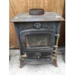 A CAST METAL LOG BURNING STOVE