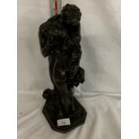 A LARGE RESIN FIGURE OF A LOVING COUPLE