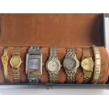 A ROUND WRISTWATCH/BRACELET CASE WITH FIVE VARIOUS WATCHES AND TWO BANGLES