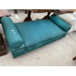 AN EARLY 20TH CENTURY DAY BED WITH FOLD-OVER TUBULAR CUSHION ENDS