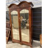 AN EARLY 20TH CENTURY INLAID MAHOGANY WARDROBE WITH TWO BEVEL EDGE MIRRORED DOORS