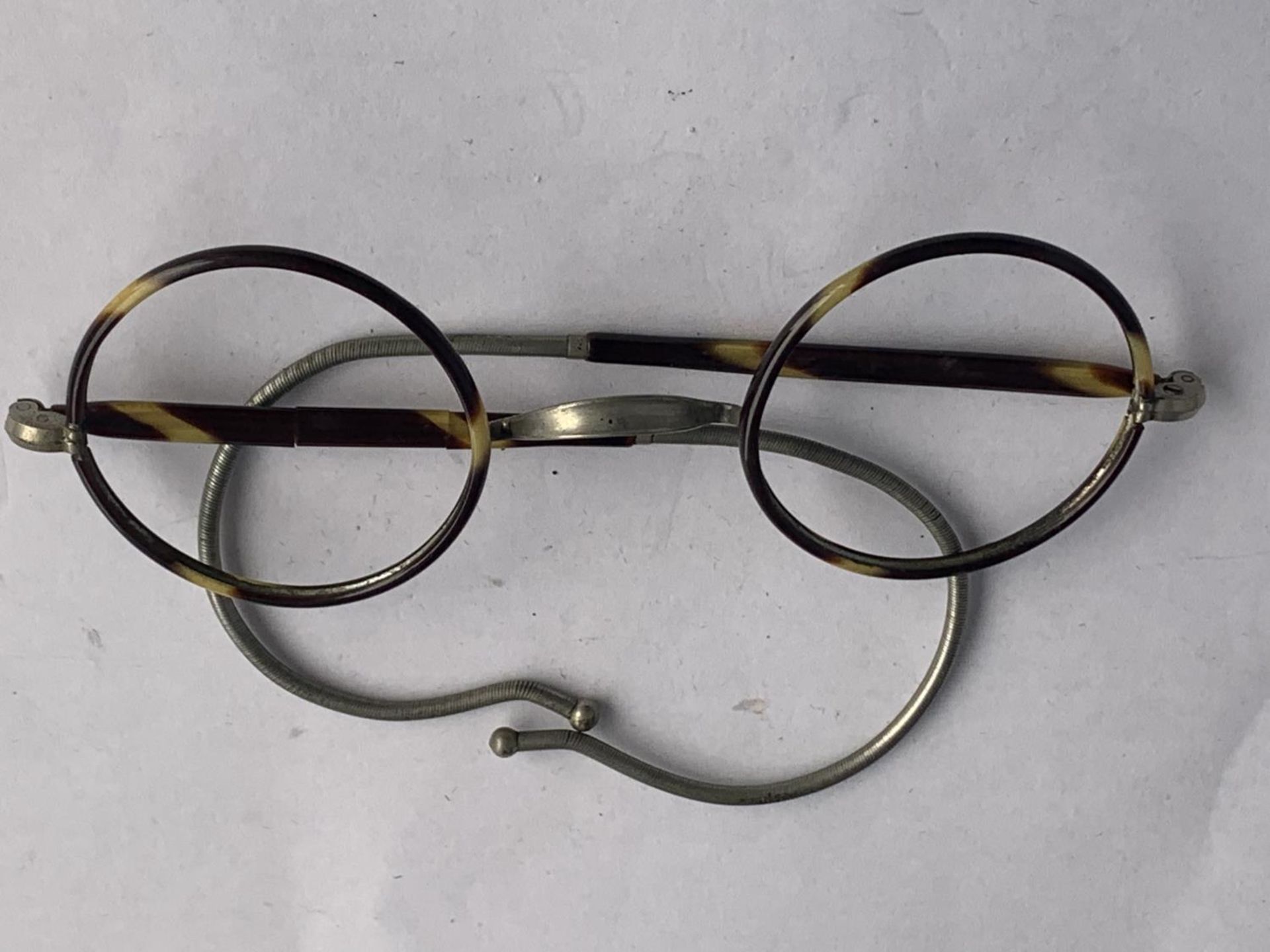 A VINTAGE PAIR OF TORTOISE SHELL SPECTACLES